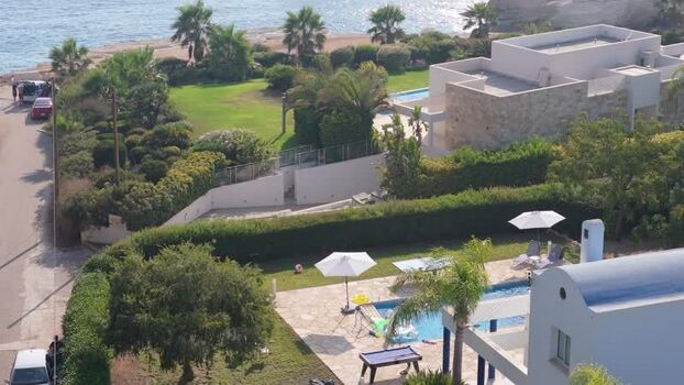 Aerial view of coastal villa with swimming pool in Cyprus.