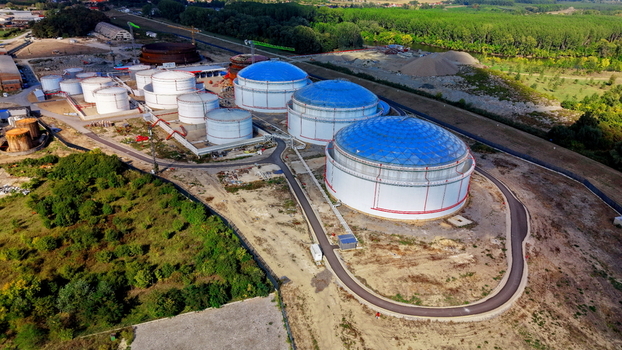 Aerial view of fuel tanks with large blue domes situated in an industrial area surrounded by lush trees and greenery in Kovin Vojvodina Serbia. Aerial view of fuel tanks with large blue domes situated in an industrial area surrounded by lush trees and greenery in Kovin Vojvodina Serbia.
