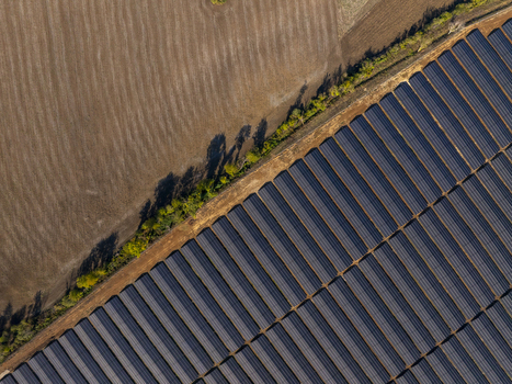 Aerial view of a large solar farm with rows of photovoltaic panels adjacent to a brown agricultural field and a line of trees in Lovech Lovech Bulgaria. Aerial view of a large solar farm with rows of photovoltaic panels adjacent to a brown agricultural field and a line of trees in Lovech Lovech Bulgaria.
