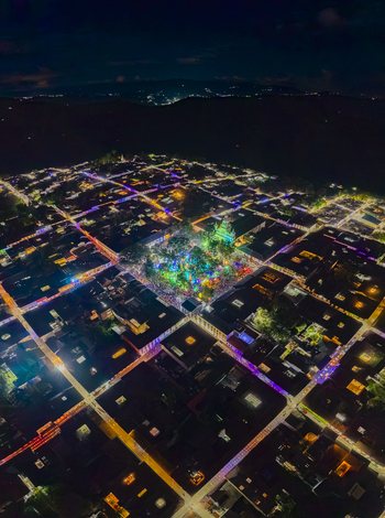 Aerial view of a grid of streets illuminated with vibrant colors leading to a central plaza bursting with bright lights Salamina Caldas Colombia. Aerial view of a grid of streets illuminated with vibrant colors leading to a central plaza bursting with bright lights Salamina Caldas Colombia.