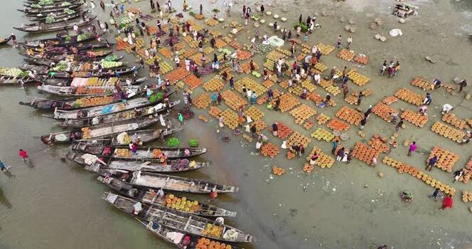 Aerial view of a busy riverside market with boats Bangladesh. Aerial view of a busy riverside market with boats Bangladesh.