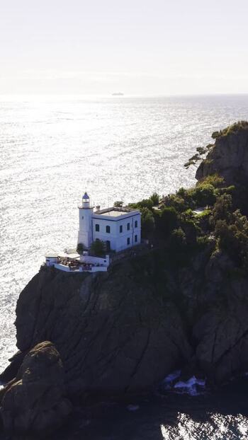 Aerial view of the Portofino Lighthouse on a rocky cliff Italy.