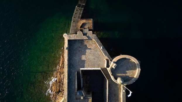 Aerial view of the Château du Taureau a stone fortress with a circular tower standing defiant against the dark sea Plouezoc h Bretagne France. Aerial view of the Château du Taureau a stone fortress with a circular tower standing defiant against the dark sea Plouezoc h Bretagne France.