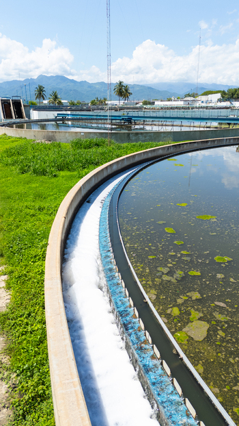 Aerial view of water treatment facility s circular sedimentation tanks contrasting with the lush green surroundings Puerto Vallarta Mexico. Aerial view of water treatment facility s circular sedimentation tanks contrasting with the lush green surroundings Puerto Vallarta Mexico.