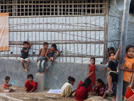 Cox s Bazar Bangladesh 19 July 2026 View of children playing near a makeshift bamboo and plastic shelter at the Rohingya refugee camp.