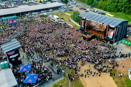 Geiselwind Germany 20 June 2025 Aerial view of Heroes Festival Geiselwind with a large crowd gathered in front of the main stage and surrounding festival infrastructure.