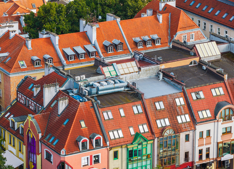 Aerial view of the historic old town in Olsztyn featuring colorful buildings with red tiled roofs and dormer windows in Olsztyn Warmian Masurian Voiv Poland. Aerial view of the historic old town in Olsztyn featuring colorful buildings with red tiled roofs and dormer windows in Olsztyn Warmian Masurian Voiv Poland.