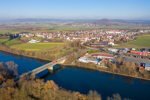 Aerial view of the Liapor GmbH Co. KG industrial facility and a bridge crossing the Regnitz river with the village in the background Hallerndorf Bayern Germany. Aerial view of the Liapor GmbH Co. KG industrial facility and a bridge crossing the Regnitz river with the village in the background Hallerndorf Bayern Germany.