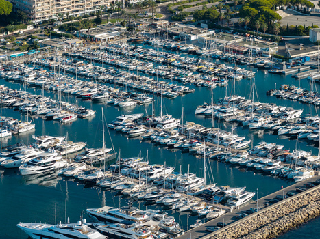 Aerial view of the marina in Antibes filled with numerous yachts and boats docked in rows with clear blue water and coastal infrastructure in Antibes Provence Alpes Cote d Azur France. Aerial view of the marina in Antibes filled with numerous yachts and boats docked in rows with clear blue water and coastal infrastructure in Antibes Provence Alpes Cote d Azur France.