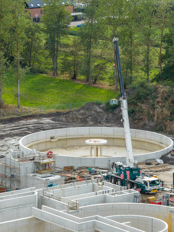 Vilvoorde Flanders Belgium 30 August 2026 Aerial view of the wastewater treatment plant construction site with a large circular concrete tank and a mobile crane. Vilvoorde Flanders Belgium 30 August 2026 Aerial view of the wastewater treatment plant construction site with a large circular concrete tank and a mobile crane.