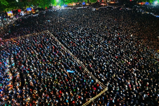 Dhaka Bangladesh 20 July 2026 Aerial view of a massive crowd of people gathered at Mohsin Hall Playground at night illuminated by event lighting. Dhaka Bangladesh 20 July 2026 Aerial view of a massive crowd of people gathered at Mohsin Hall Playground at night illuminated by event lighting.