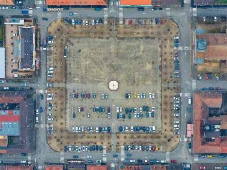 Aerial view of the Place d Armes a military square surrounded by historic buildings and parked cars showcasing the symmetrical layout and architectural details Neuf Brisach Grand Est France.