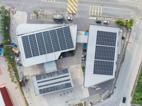 Bukit Tambun Penang Malaysia 25 September 2026 Aerial view of solar panels installed on the roof of a modern commercial building with parking spaces and surrounding roads.