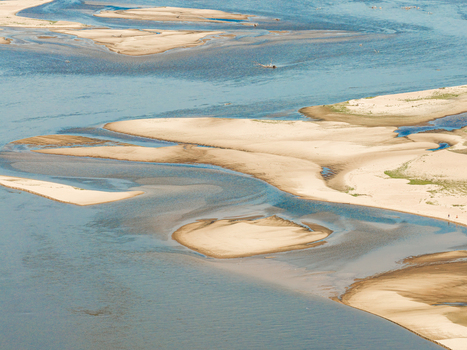 Aerial view of low water levels in the river exposing large sandbars and intricate channels in Poland.