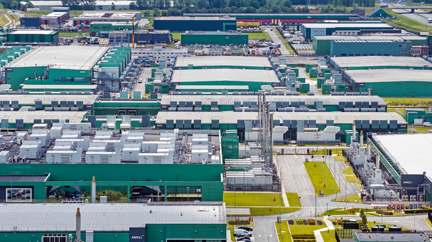 Aerial view of a large data center complex featuring green industrial buildings extensive rooftop HVAC infrastructure and paved access roads in Middenmeer North Holland Netherlands.