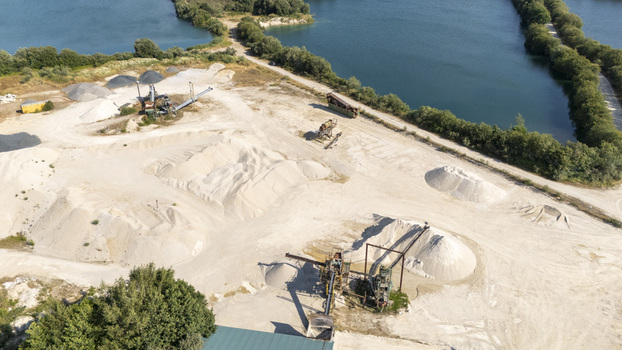 Aerial view of the Extraccion de aridos Lima S.L sand extraction site with machinery conveyor belts and piles of sand near water bodies in Vilarino das Poldras Ourense Spain. Aerial view of the Extraccion de aridos Lima S.L sand extraction site with machinery conveyor belts and piles of sand near water bodies in Vilarino das Poldras Ourense Spain.