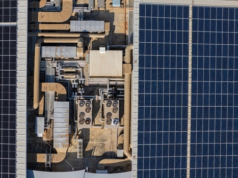 Aerial view of solar panels installed on a commercial rooftop with complex HVAC ventilation systems and metallic pipes in Cascais Lisboa Portugal. Aerial view of solar panels installed on a commercial rooftop with complex HVAC ventilation systems and metallic pipes in Cascais Lisboa Portugal.