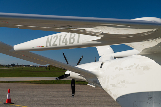 Visby Sweden 07 May 2026 View of the white fuselage and propellers of BETA technologies aircraft parked on the tarmac at Visby Airport under a clear blue sky.