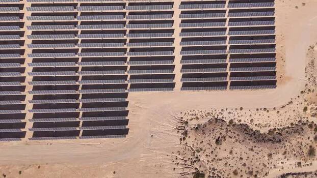 Aerial view of rows of solar panels in a desert landscape United States.