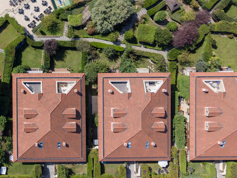 Aerial view of residential buildings with red tiled roofs and dormer windows surrounded by lush green gardens and manicured hedges in Istanbul Istanbul Turkiye. Aerial view of residential buildings with red tiled roofs and dormer windows surrounded by lush green gardens and manicured hedges in Istanbul Istanbul Turkiye.