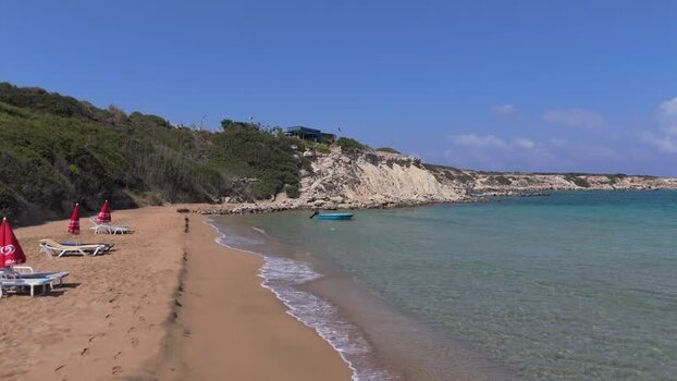 Aerial view of sandy beach with red umbrellas in Northern Cyprus.