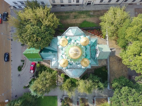 Aerial view of the Russian Church of St. Nicholas the Miracle Maker with its distinctive golden domes and green roof surrounded by lush trees in Sofia Sofia City Province Bulgaria.