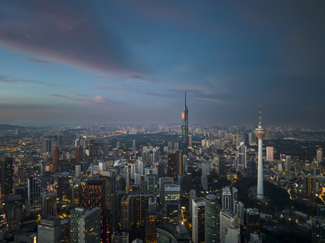 Kuala Lumpur Malaysia 11 March 2026 Aerial view of the city skyline at dusk featuring the Merdeka 118 skyscraper and KL Tower under a dramatic twilight sky.