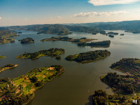 Aerial view of Lake Bunyonyi featuring numerous lush green islands terraced hillsides and calm waters in Kabale Western Region Uganda.