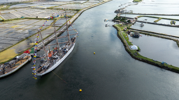 Aerial view of the tall ship NRP Sagres decorated with signal flags navigating the Canal de Aveiro near the salt pans Aveiro Aveiro Portugal. Aerial view of the tall ship NRP Sagres decorated with signal flags navigating the Canal de Aveiro near the salt pans Aveiro Aveiro Portugal.