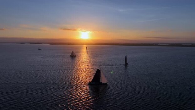 Aerial view of sailboats on a lake at sunset in Heeg Netherlands.