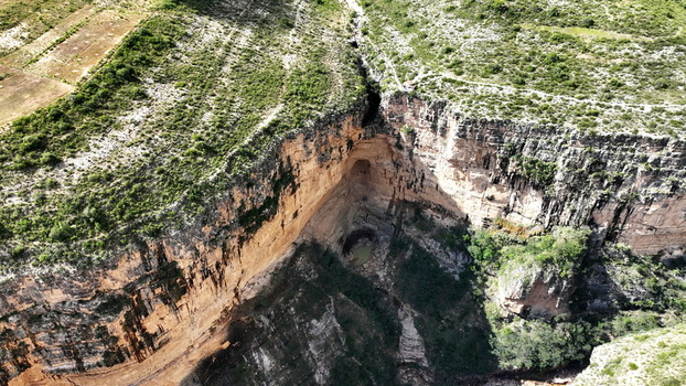 Aerial view of El Vergel canyon featuring steep rocky cliffs lush green vegetation and a deep gorge in Torotoro Potosi Department Bolivia. Aerial view of El Vergel canyon featuring steep rocky cliffs lush green vegetation and a deep gorge in Torotoro Potosi Department Bolivia.