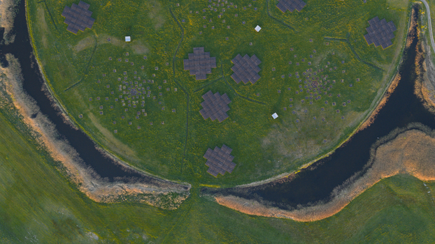 Aerial view of the LOFAR superterp radio telescope antenna arrays on a circular green field surrounded by water channels in Buinen Drenthe Netherlands. Aerial view of the LOFAR superterp radio telescope antenna arrays on a circular green field surrounded by water channels in Buinen Drenthe Netherlands.
