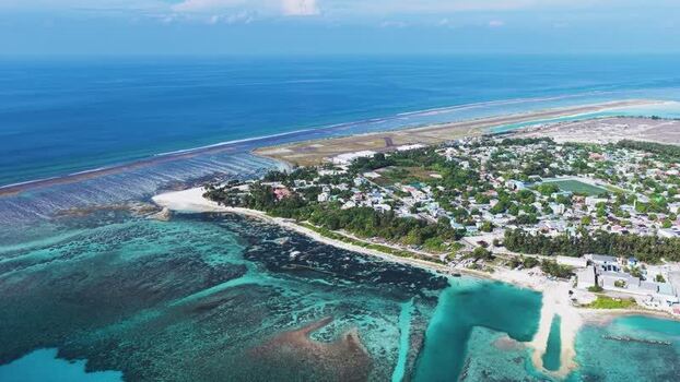 Aerial view of Kudahuvadhoo island and coral reefs Maldives. Aerial view of Kudahuvadhoo island and coral reefs Maldives.