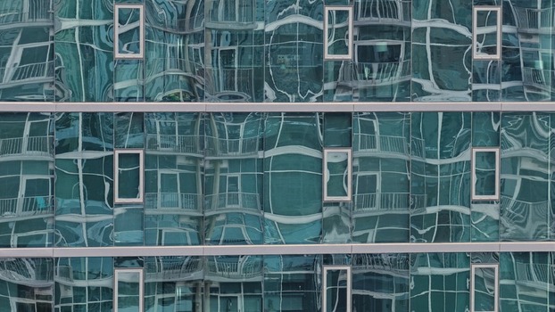 Aerial view of modern glass building facade with reflective windows and geometric architectural patterns in Denver Colorado United States. Aerial view of modern glass building facade with reflective windows and geometric architectural patterns in Denver Colorado United States.