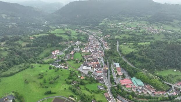 Aerial view of serene village in valley surrounded by mountains Spain.