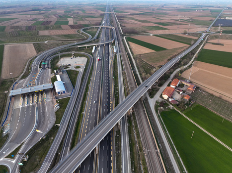 Aerial view of the Autostrada Torino Milano interchange and toll plaza with surrounding agricultural fields and railway tracks in Borgo d Ale Piedmont Italy. Aerial view of the Autostrada Torino Milano interchange and toll plaza with surrounding agricultural fields and railway tracks in Borgo d Ale Piedmont Italy.