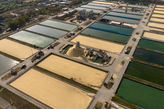 Aerial view of Ashford Common Water Treatment Works featuring large filtration beds industrial machinery and sand filters in Shepperton England United Kingdom. Aerial view of Ashford Common Water Treatment Works featuring large filtration beds industrial machinery and sand filters in Shepperton England United Kingdom.