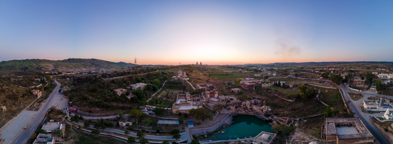 Aerial view of the historic Katas Raj Temple Complex featuring its sacred pond and ancient stone architecture set within the landscape of Katas Punjab Pakistan. Aerial view of the historic Katas Raj Temple Complex featuring its sacred pond and ancient stone architecture set within the landscape of Katas Punjab Pakistan.