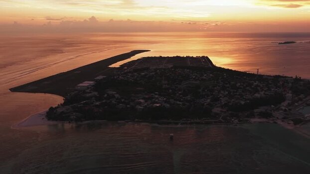 Aerial view of Kudahuvadhoo island at sunset Maldives.