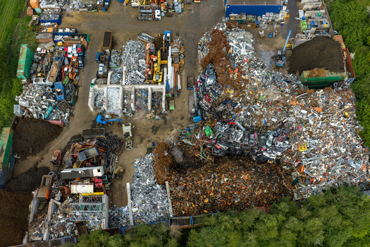 Aerial view of scrapped cars and crushed metal debris piled in a junkyard and recycling site in Hoogeveen Drenthe Netherlands. Aerial view of scrapped cars and crushed metal debris piled in a junkyard and recycling site in Hoogeveen Drenthe Netherlands.