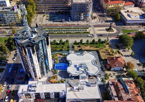 Aerial view of a modern tower with a telecommunications antenna surrounded by urban streets a park and buildings in Krusevac Rasina District Serbia. Aerial view of a modern tower with a telecommunications antenna surrounded by urban streets a park and buildings in Krusevac Rasina District Serbia.