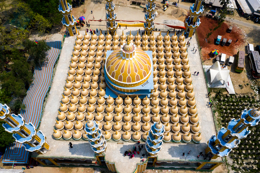 Aerial view of the golden domed mosque with hundreds of smaller domes and ornate blue minarets Tangail Dhaka Division Bangladesh. Aerial view of the golden domed mosque with hundreds of smaller domes and ornate blue minarets Tangail Dhaka Division Bangladesh.