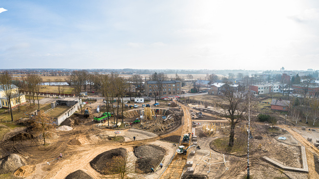 Aerial view of a construction site for a new park featuring earthworks and wooden structures in Latvia. Aerial view of a construction site for a new park featuring earthworks and wooden structures in Latvia.
