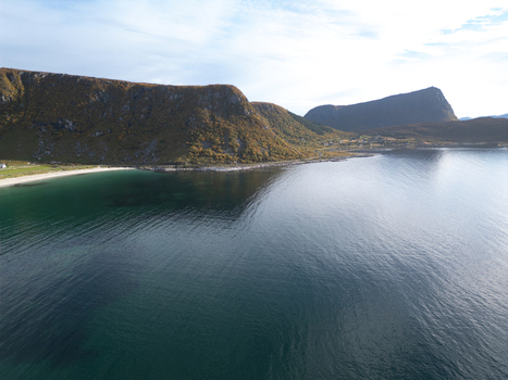 Aerial view of Vik Strand beach with turquoise water and steep mountains covered in autumn foliage Leknes Nordland Norway. Aerial view of Vik Strand beach with turquoise water and steep mountains covered in autumn foliage Leknes Nordland Norway.