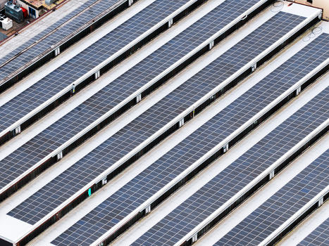 Aerial view of rows of solar panels installed on a large industrial rooftop under bright daylight Leccio Toscana Italy. Aerial view of rows of solar panels installed on a large industrial rooftop under bright daylight Leccio Toscana Italy.