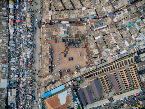 Aerial view of Panteka Market featuring dense rooftops a central courtyard with vehicles and crowded market stalls in Kaduna Kaduna Nigeria. Aerial view of Panteka Market featuring dense rooftops a central courtyard with vehicles and crowded market stalls in Kaduna Kaduna Nigeria.