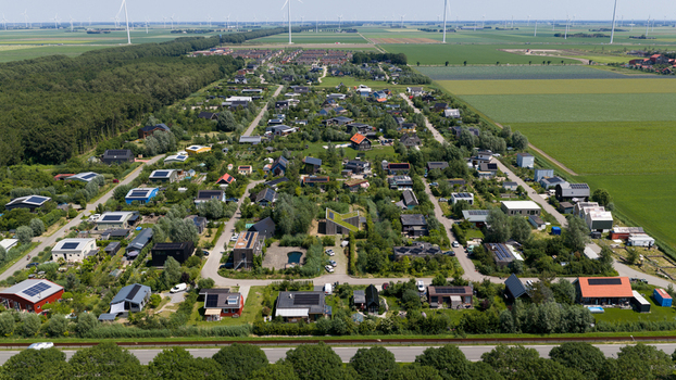 Aerial view of Ecodorp Bolderburen a sustainable eco village with modern houses solar panels and lush gardens surrounded by green fields in Almere Flevoland Netherlands. Aerial view of Ecodorp Bolderburen a sustainable eco village with modern houses solar panels and lush gardens surrounded by green fields in Almere Flevoland Netherlands.