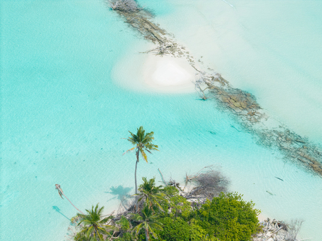 Aerial view of turquoise waters meet the sandy beach and lush greenery creating a stunning contrast of colors and textures Thuraakunu Thiladhunmathee Uthuruburi Maldives. Aerial view of turquoise waters meet the sandy beach and lush greenery creating a stunning contrast of colors and textures Thuraakunu Thiladhunmathee Uthuruburi Maldives.