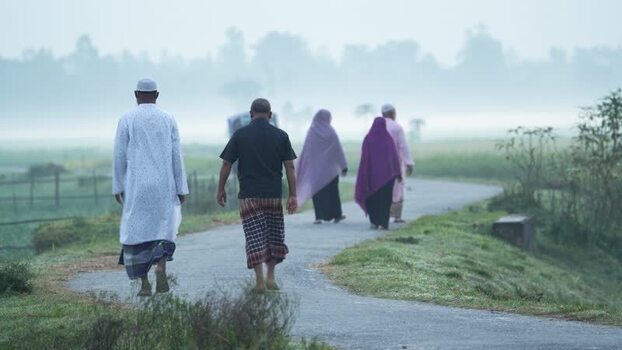 View of people walking on a rural road in Bogura Bangladesh.