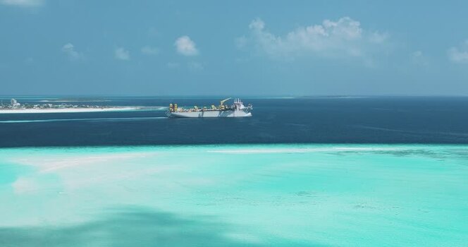 Aerial view of a large industrial ship in turquoise waters Maldives. Aerial view of a large industrial ship in turquoise waters Maldives.